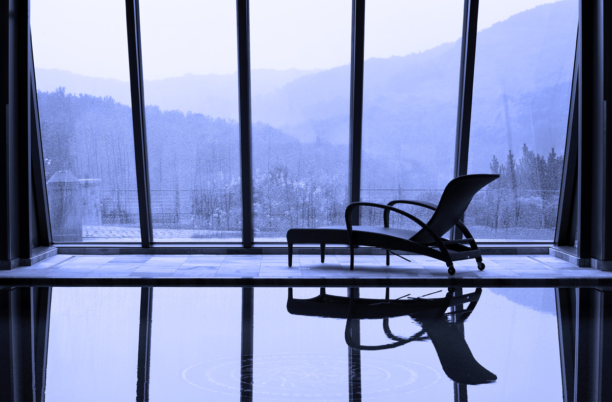 Indoor pool, calm, peaceful view, lounger, photography of blue mountains through a window